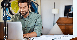 Man booking residential shredding on laptop