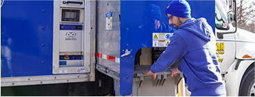 TITAN Mobile Shredding shredding truck employee loading documents onto truck