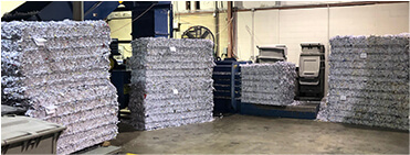 Stacks of shredded documents in warehouse