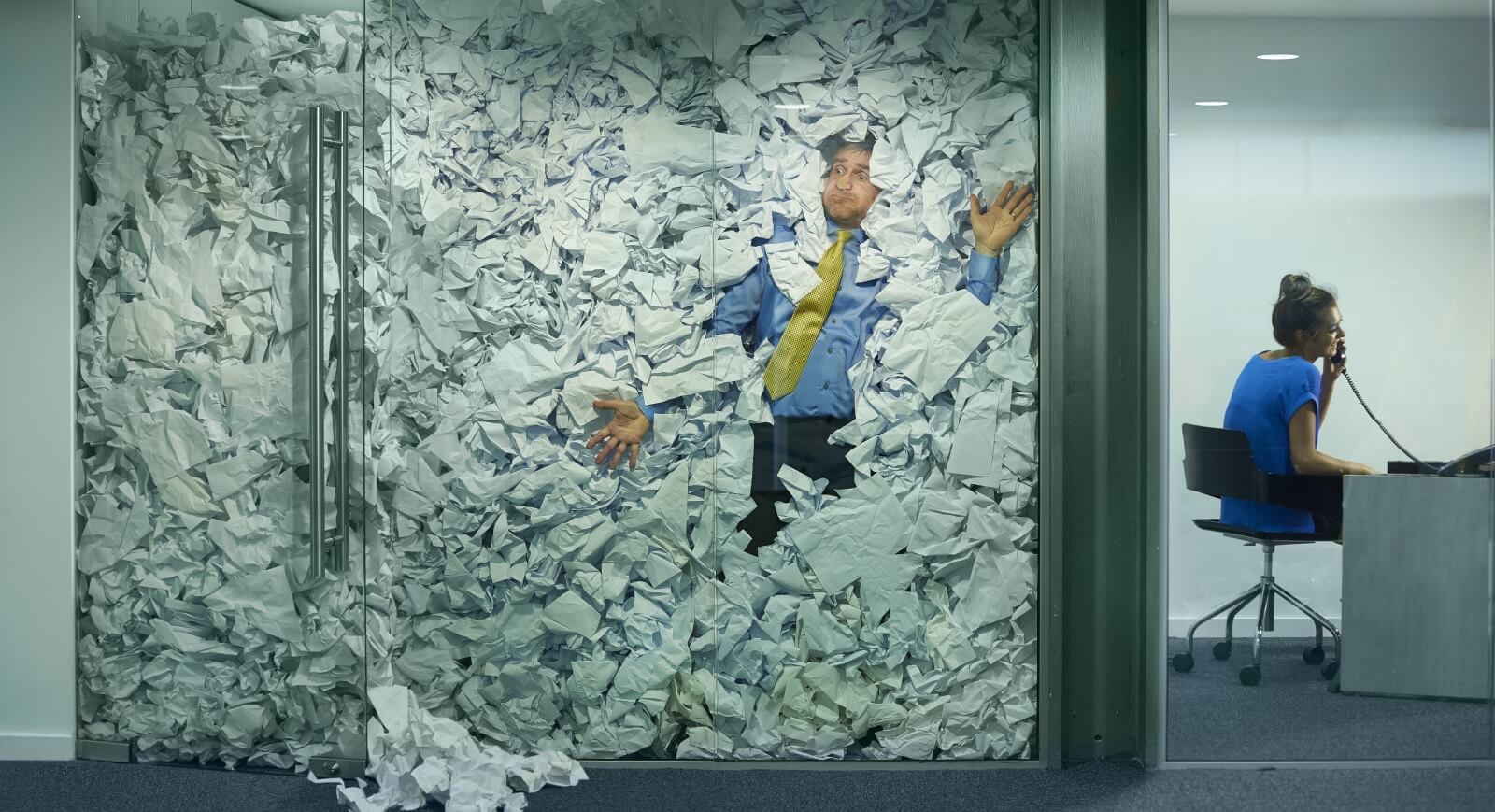 Man trapped in office overflowing with paper documents