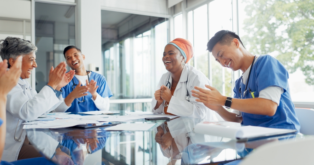 a group of healthcare professionals laughing at a table