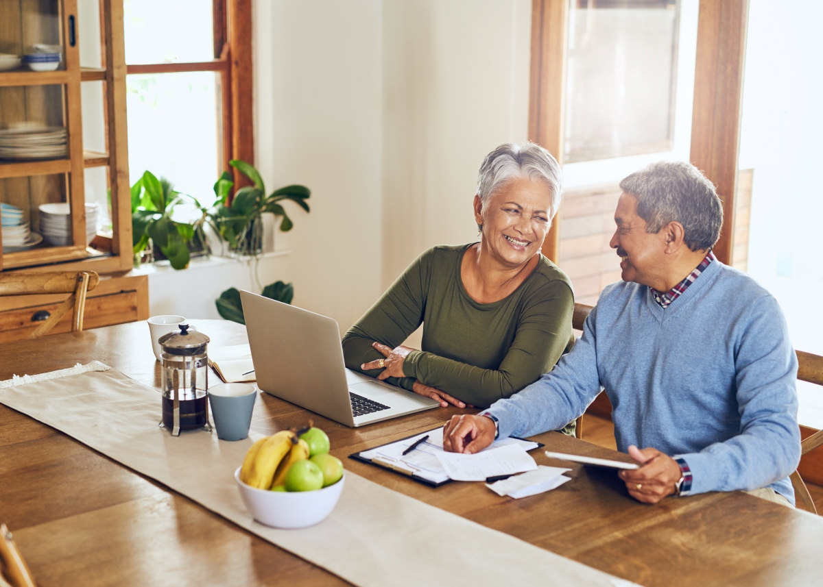 Residential homeowners looking at paperwork smiling