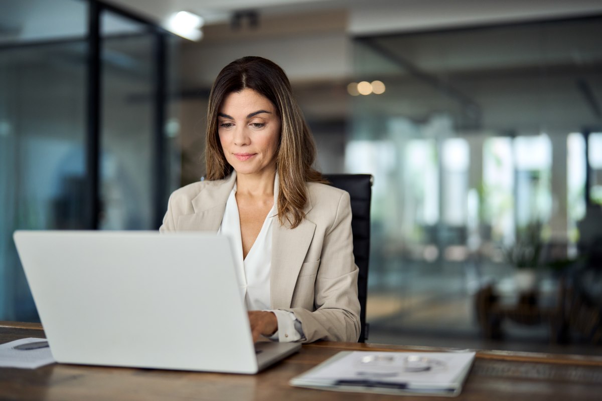 Office worker looking at data on a laptop