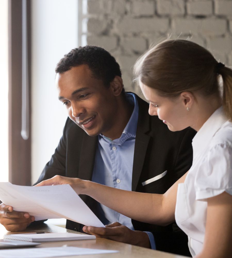 an insurance agent helping a client by going over some documents.
