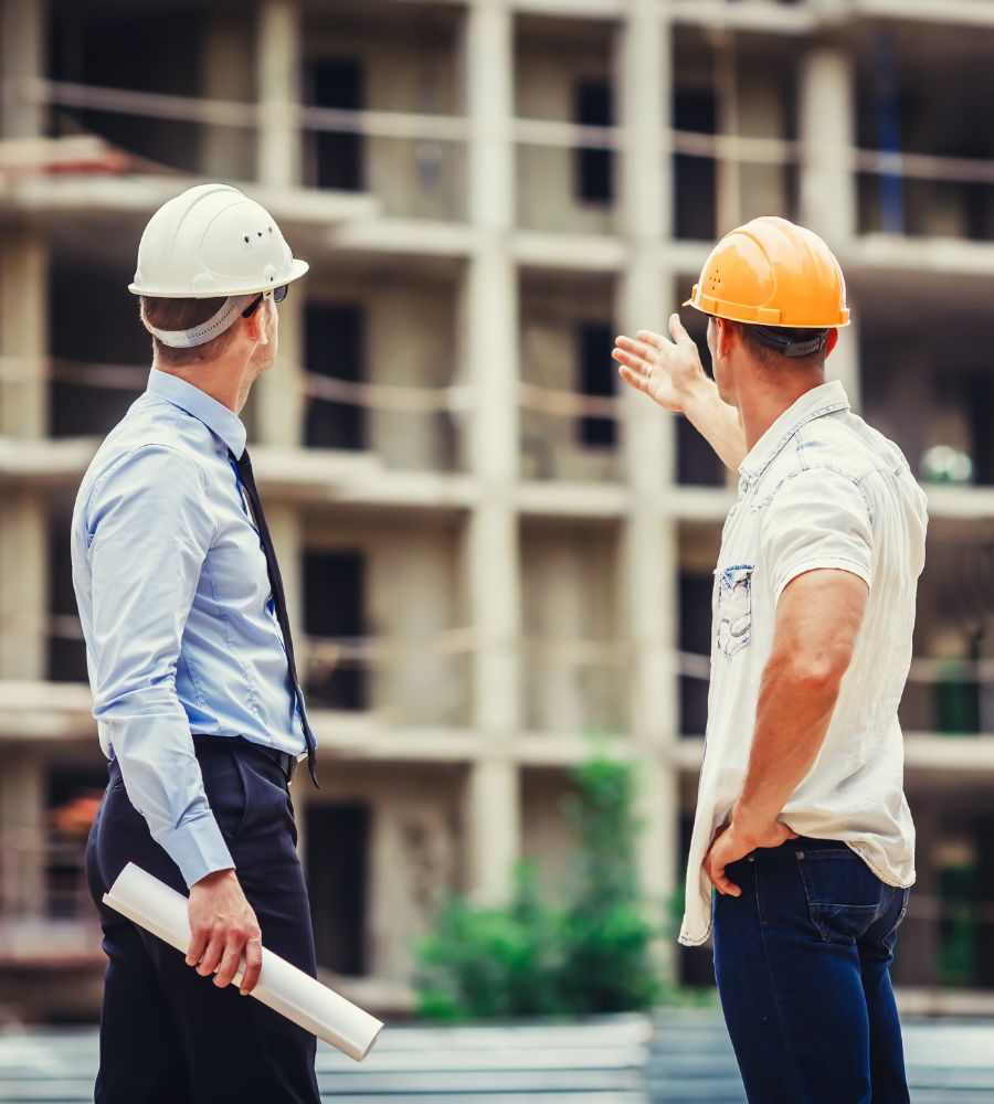a construction team talking about the building in front of them