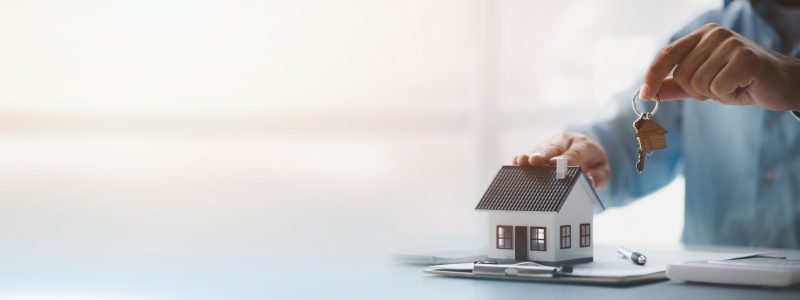 Real estate agents explain models of housing estates in projects to elaborate to clients, explaining and presenting information about homes and purchasing loans. Real estate trading concept.